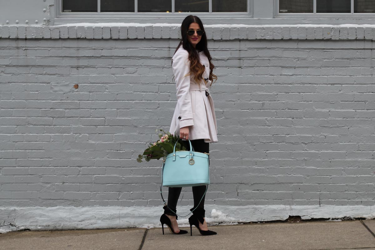 White coat and leather leggings and bow heels and Henri Bendel purse