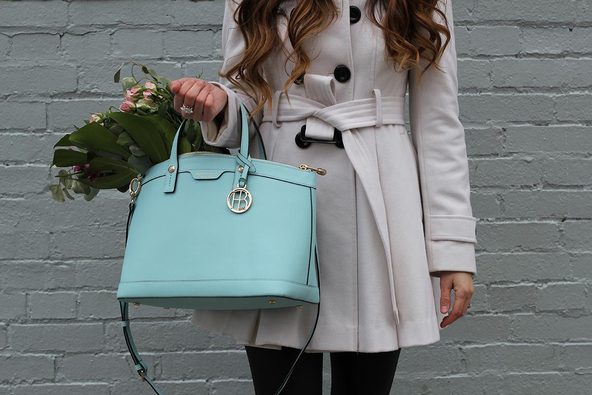 White coat and leather leggings and Henri Bendel purse