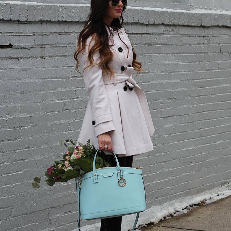 White coat and leather leggings and bow heels and Henri Bendel purse