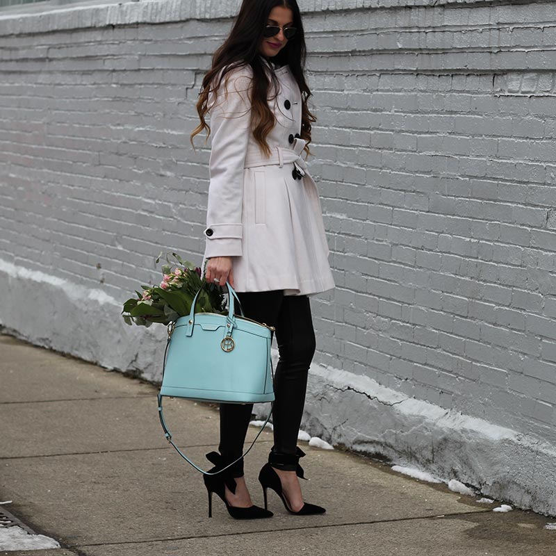 White coat and leather leggings and bow heels and Henri Bendel purse